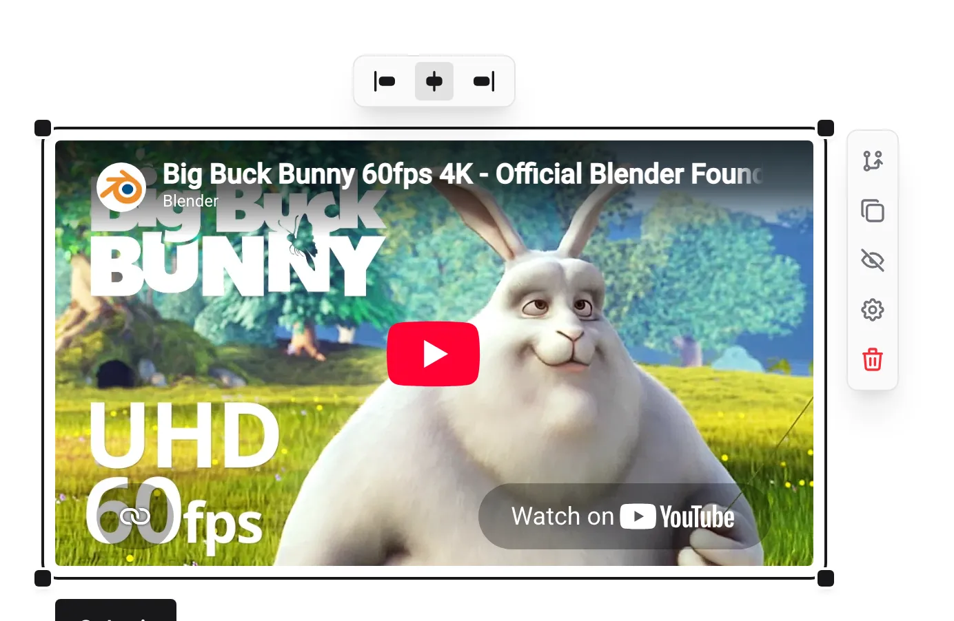 A selected Media component showing a YouTube video, with the alignment bubble above it and resize handles on its corners